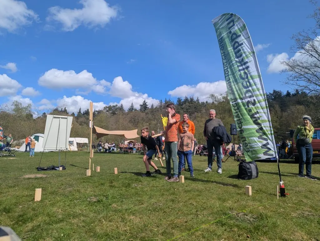 Kinderen lachen en spelen samen tijdens een kubbworkshop van SpeelKubb.